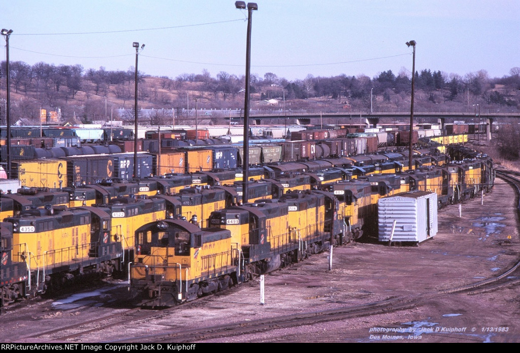 Storage, and SO MUCH to see here. GP7s, GP30s Fs, cabooses, and freight cars with no graffiti. C&NW, yard, Des Moines, Iowa. January 13, 1983. 